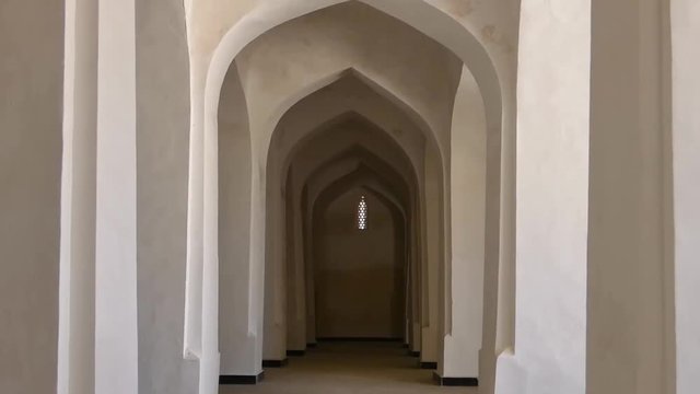 White columns and arches of the corridor in Kalyan mosque. Ancient buildings of medieval Asia. Bukhara, Uzbekistan