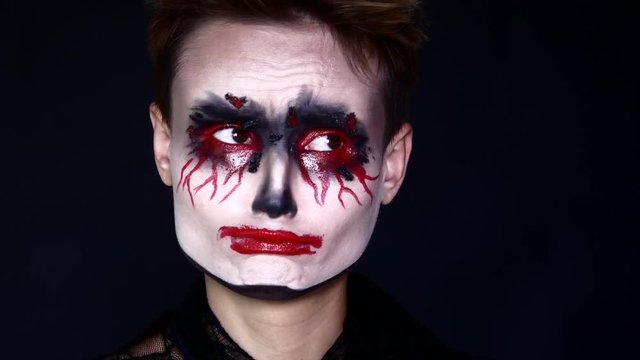 Sad joker. Woman in Halloween Makeup.