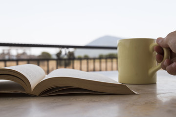 reading book concept for shop. book and coffee on the background at the outside.