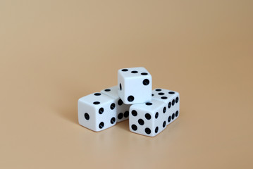Five dice on a soft brown background.