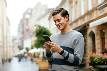 Man Using Phone On Street 