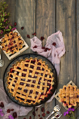 Traditional American cherry pie on a dark wooden background