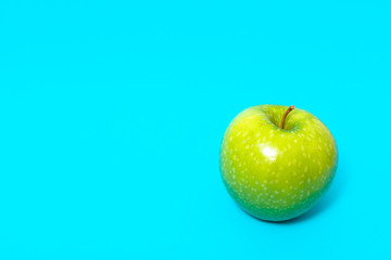 Green apple isolated on blue background