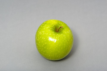 Perfect fresh green apple isolated on gray background