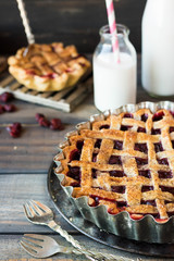 Traditional American cherry pie on a dark wooden background