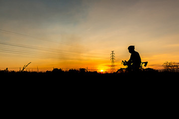 Silhouette of Men's Cycling At sunset