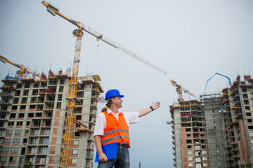 Architect showing buildings on a construction site during a housing project