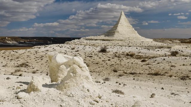 Unique pyramid rock on the white chalky plain of Aktolagay in Kasakhstan slider 4K
