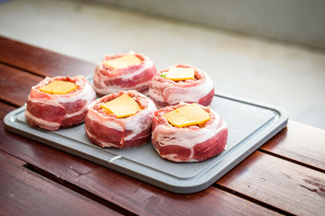 Making home made Beer Can Bacon Burgers on barbecue grill.
