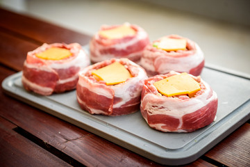 Making home made Beer Can Bacon Burgers on barbecue grill.