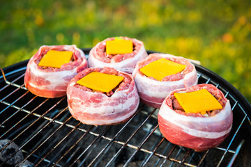 Making home made Beer Can Bacon Burgers on barbecue grill.