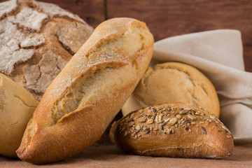 Composition of rustic bread on wooden table