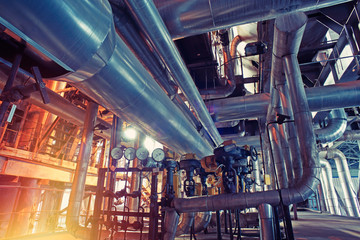 Equipment, cables and piping as found inside of a modern industrial power plant. Industrial zone,...