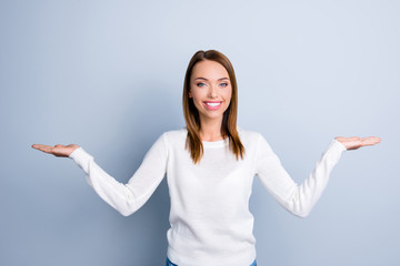 Portrait of stylish brunette woman in white sweater holding in t