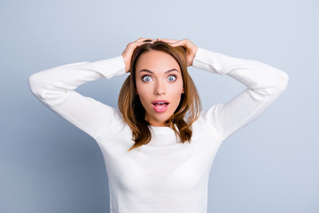 Naklejka premium Portrait of emotional shocked girl holding hands on head with wi