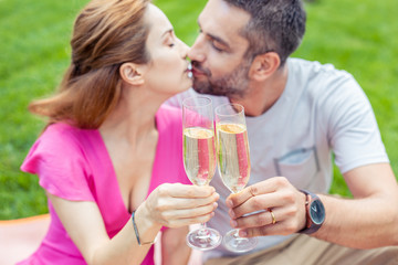 Reason to celebrate. Selective focus of two glasses with champagne being clinked together while celebrating their anniversary