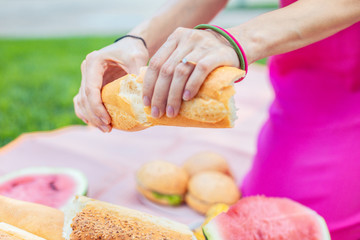 Fresh bread. Selective focus of tasty fresh bread served by a pleasant nice woman while preparing food for the picnic