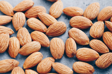 Fresh almond nuts. Food background, macro photography.