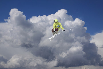 Flying skier on mountains. Extreme winter sport.