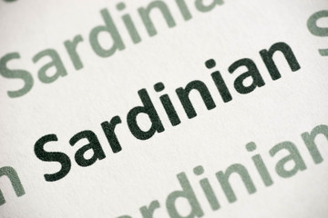 word Sardinian language printed on paper macro