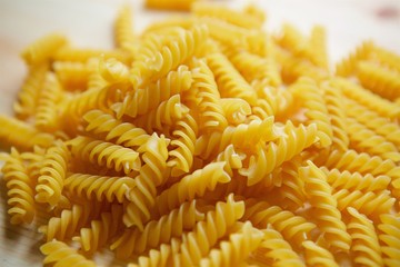 On the wooden surface lay a wet noodle in a spiral shape