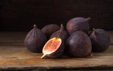 Ripe figs on old wooden table - 221080038