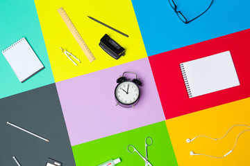 school supplies at colorful paper background