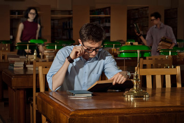 guy with books in the library