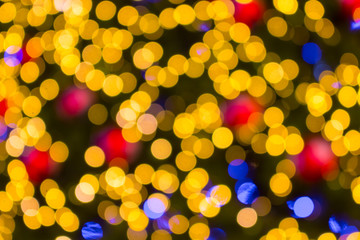 Golden Bokeh of Christmas balls and Christmas tree with light