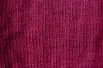 Fototapeta premium trend red pear woolen knitted background, texture, close-up