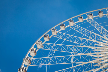 White big Ferris wheel  with blue sky sharp clouds