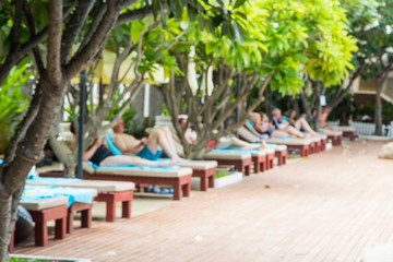 Blur and defocus of alot of Tourists relax on the pool deck