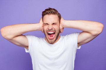 Portrait of handsome bearded crazy violent screaming guy coverin