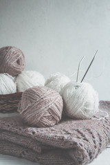 Tubes of wool thread and knitting needles for knitting handmade hobby in Scandinavian style...