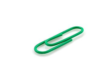 Single Green paper clip isolated on white