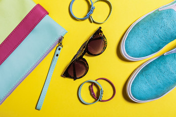 Stylish accessories for ladies. Fashionable sunglasses, colored bag, aquamarine shoes and little belts. Spring summer hipster trend. Top view. mockup for instagram