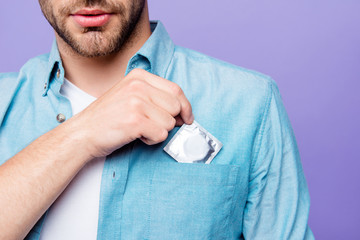 Safe sexual relations concept. Cropped close-up photo of bearded