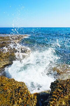Wave breaking on the stones at the seashore