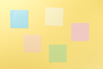 Fototapeta premium Colorful paper stickers on yellow background. Top view. Flat lay. Copy space. Concept. Mock-up lot of color empty office stickers on a yellow background