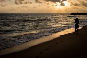 Alone and sad at the beach before sunrise silhouette style
