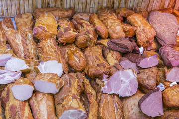 Deli display cold meat and salami. Smoked meat on shop window in store. Balyks and various meat delicacies