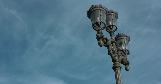 Old rustic street lamps in central Stockholm. Moving 4K slow motion shot with a blue sky backdrop.