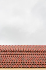 Roof tile pattern over sky background