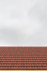 Roof tile pattern over sky background