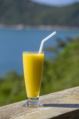Fresh organic mango shake in restaurant on the beach near sea in Thailand. Close up