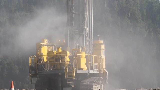 Drilling rig in the coal open pit. Drilling holes for explosives in the quarry. Slow motion, 4k, 60fps