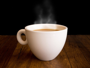 Hot coffee with steam out of a cup, on wooden table, and black background