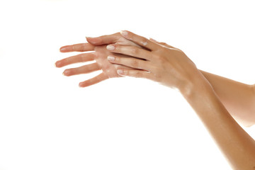 closeup of female hands applying hand cream on white background