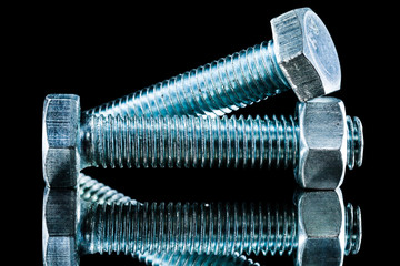 Stainless bolts on black surface