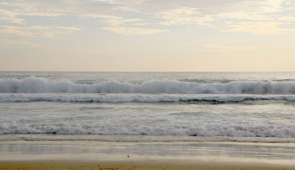 Beautiful sunset on Karon beach. The surf pounds the shore. Phuket, Thailand